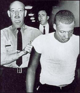 Officer escorting Ray Crump Jr.